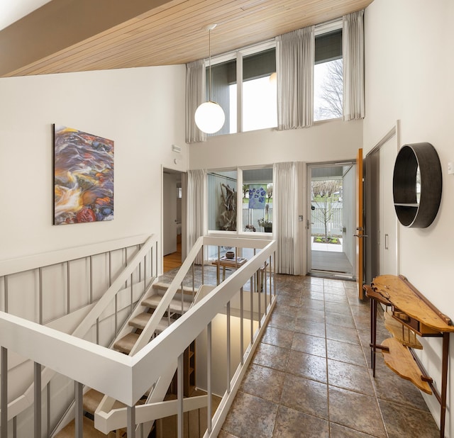 interior space with stone tile floors and a towering ceiling