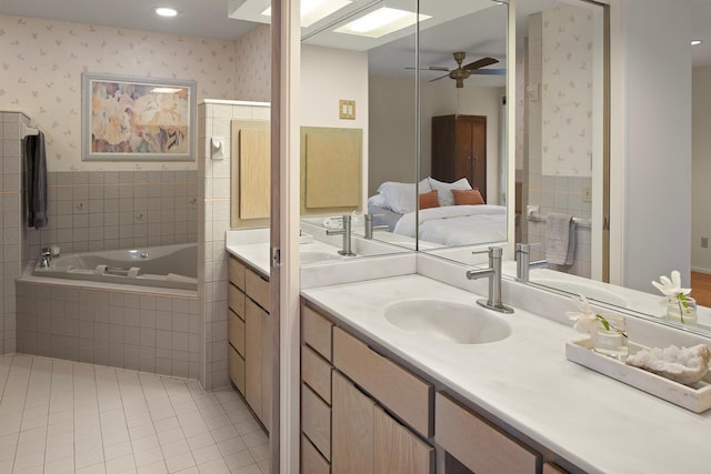ensuite bathroom featuring ensuite bath, tile patterned floors, wallpapered walls, ceiling fan, and a bath