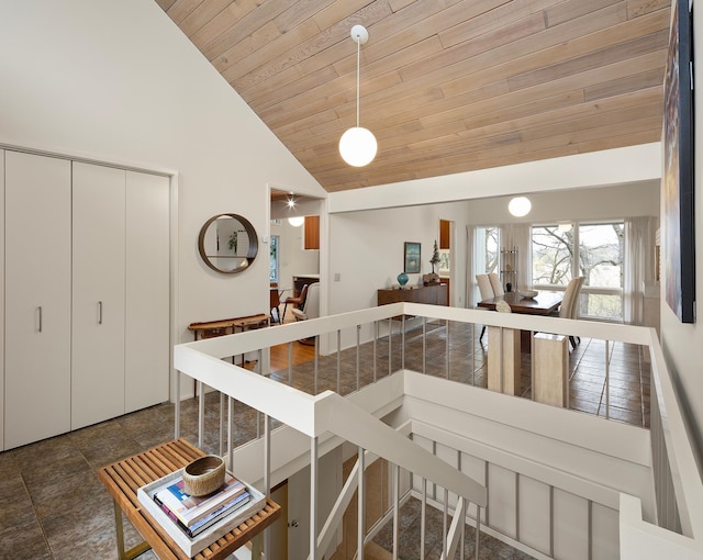 interior space featuring wooden ceiling and high vaulted ceiling