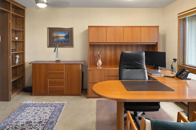 office area with a ceiling fan and light colored carpet