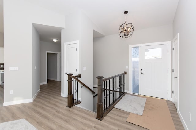 foyer with a chandelier and light hardwood / wood-style flooring