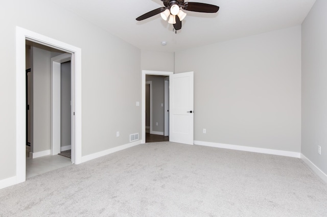 unfurnished bedroom featuring light carpet and ceiling fan