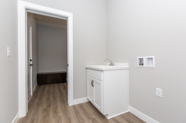 bathroom with sink and wood-type flooring