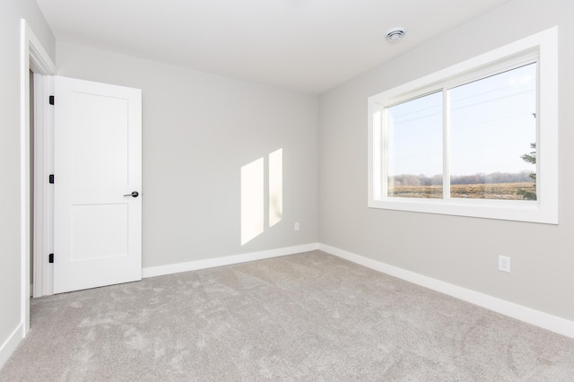 spare room with light colored carpet