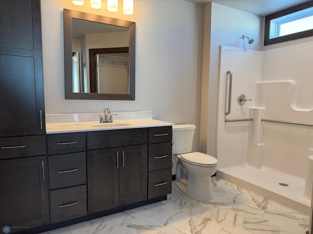 bathroom featuring walk in shower, vanity, and toilet