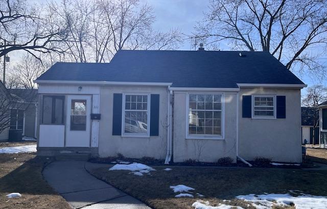 bungalow-style home with stucco siding