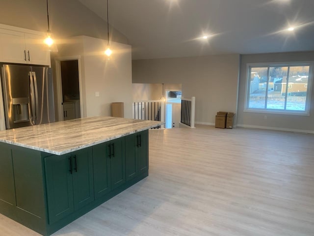 kitchen featuring white cabinetry, green cabinetry, stainless steel fridge with ice dispenser, hanging light fixtures, and light stone countertops