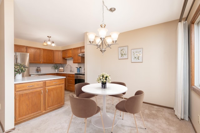 6964 Langford Ct, Edina, MN 55436 - kitchen featuring a chandelier, appliances with stainless steel finishes, light countertops, and light colored carpet