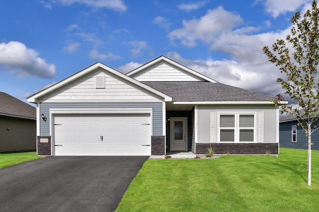 view of front facade with a garage, a shingled roof, stone siding, driveway, and a front lawn