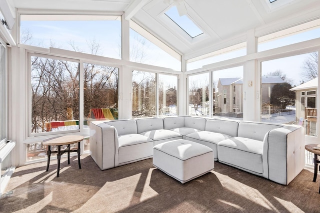 sunroom / solarium featuring lofted ceiling with skylight