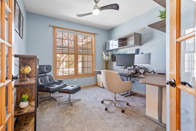 office space with carpet, baseboards, ceiling fan, and a textured ceiling