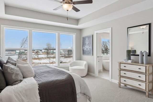 carpeted bedroom with ensuite bath and ceiling fan