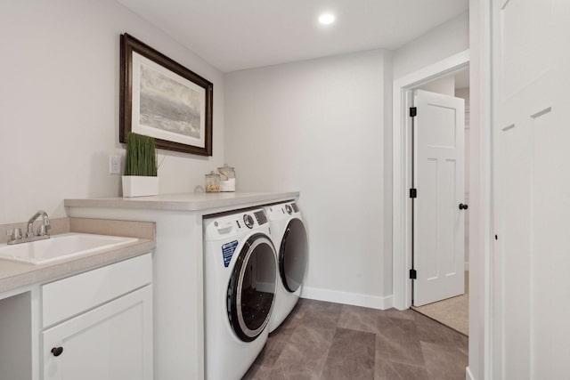 washroom with sink and washer and dryer