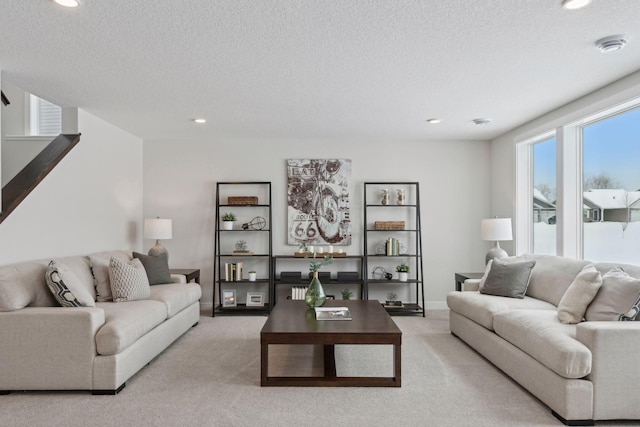 living room with light colored carpet and a textured ceiling