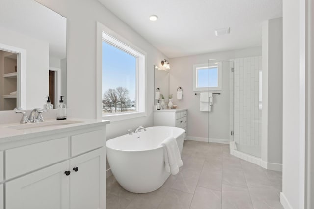 bathroom featuring tile patterned floors, vanity, and separate shower and tub