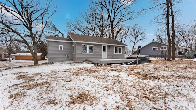 view of snow covered back of property