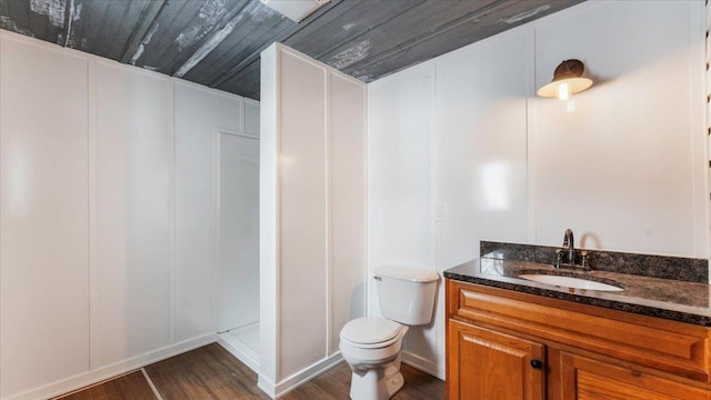 full bath with toilet, wooden ceiling, wood finished floors, walk in shower, and vanity