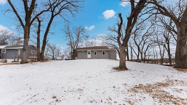 snowy yard with a detached garage