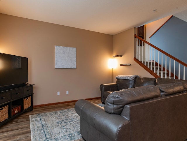 living area with stairway, dark wood finished floors, and baseboards