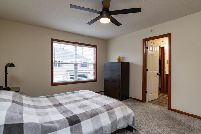 bedroom featuring light carpet, baseboards, and a ceiling fan