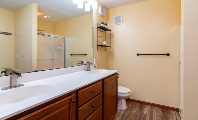 full bath with a stall shower, visible vents, a sink, and toilet