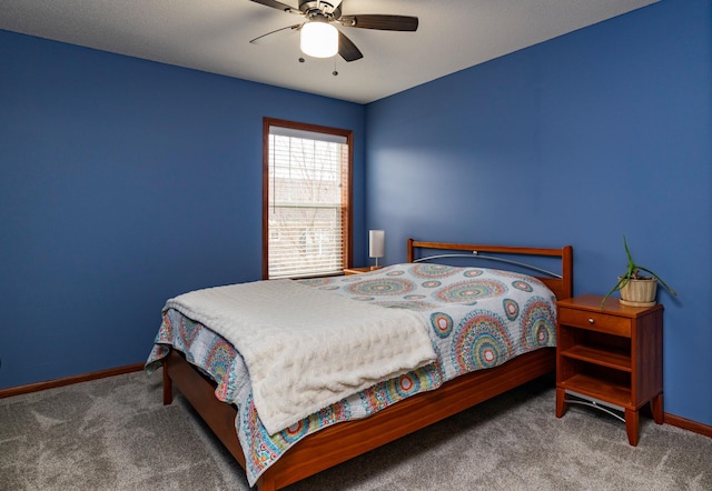 bedroom with ceiling fan, baseboards, and carpet flooring