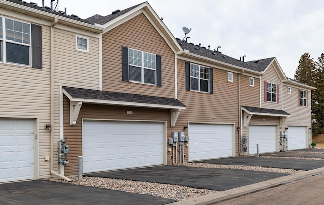 view of property featuring an attached garage and driveway