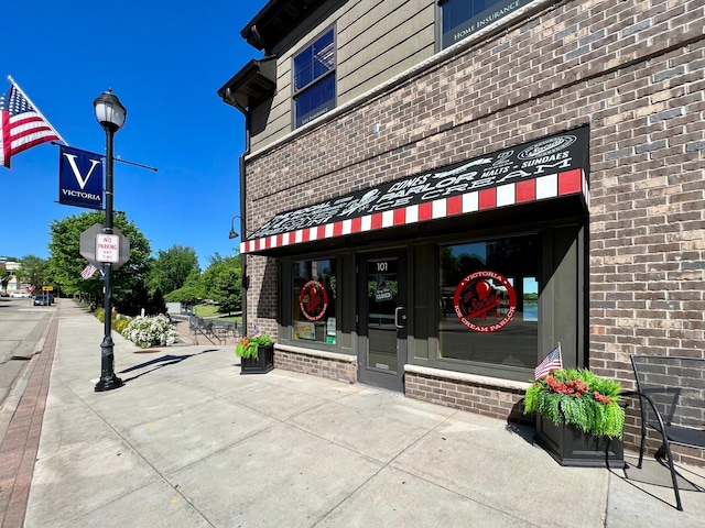 property entrance featuring brick siding