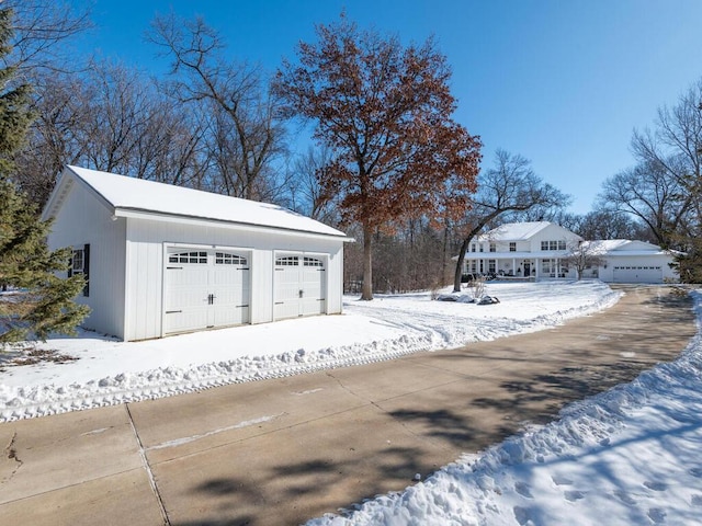 snow covered garage featuring a garage