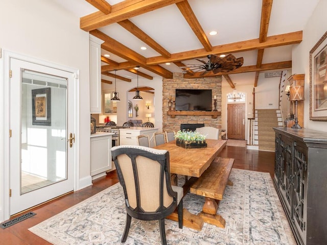 dining room with ceiling fan, beamed ceiling, dark wood-style flooring, and visible vents