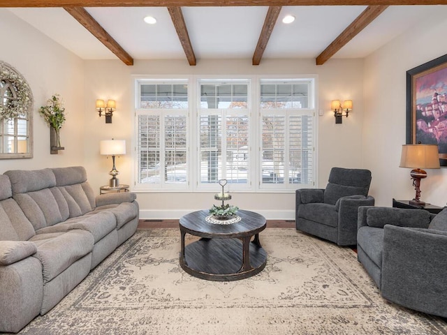 living room featuring baseboards, beamed ceiling, wood finished floors, and recessed lighting