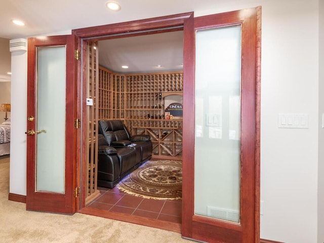 wine room featuring carpet floors, tile patterned floors, visible vents, and recessed lighting