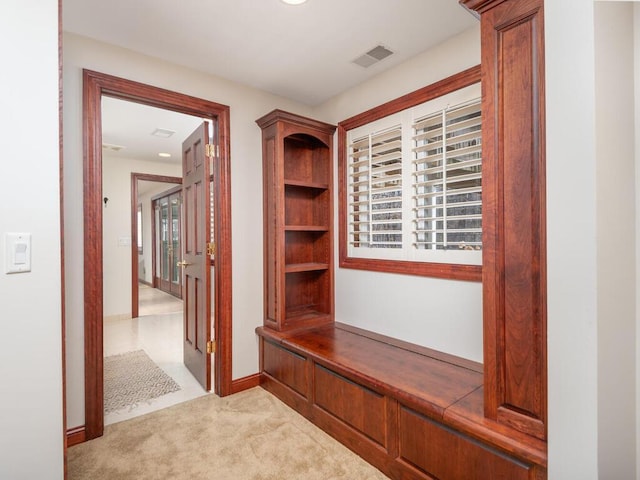 mudroom with light carpet, baseboards, and visible vents