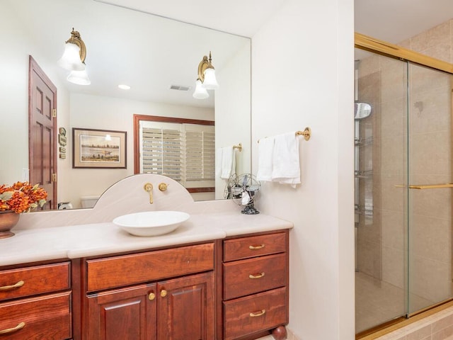 full bathroom with visible vents, a stall shower, and vanity