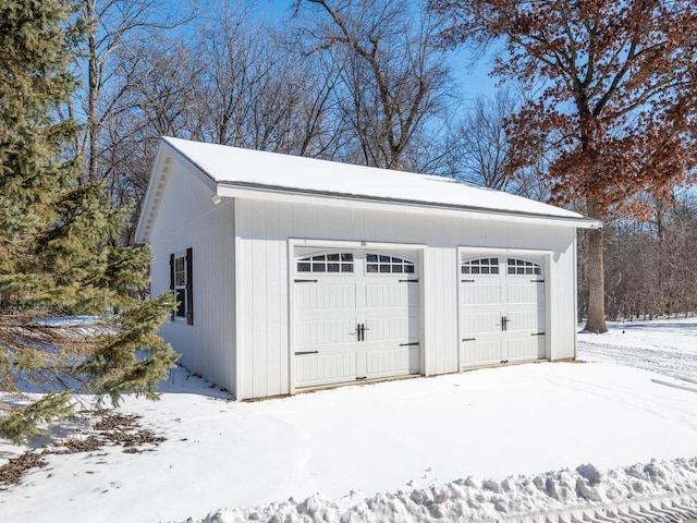 snow covered garage with a garage