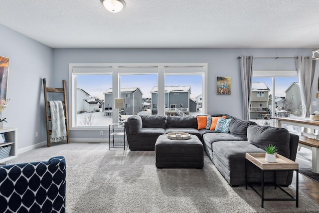 carpeted living room with a textured ceiling and a healthy amount of sunlight