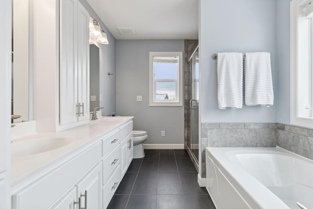 full bathroom with plus walk in shower, tile patterned flooring, vanity, and toilet