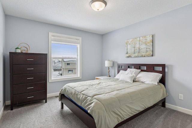 carpeted bedroom featuring a textured ceiling