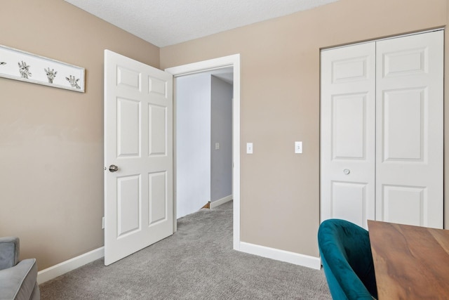 office space with light carpet and a textured ceiling