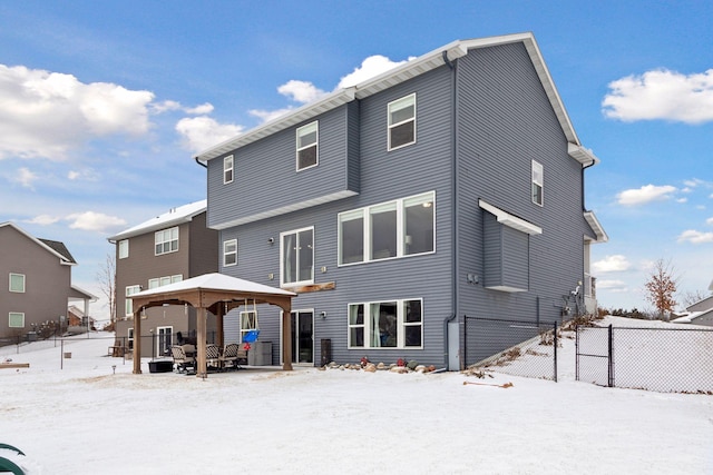 snow covered rear of property featuring a gazebo