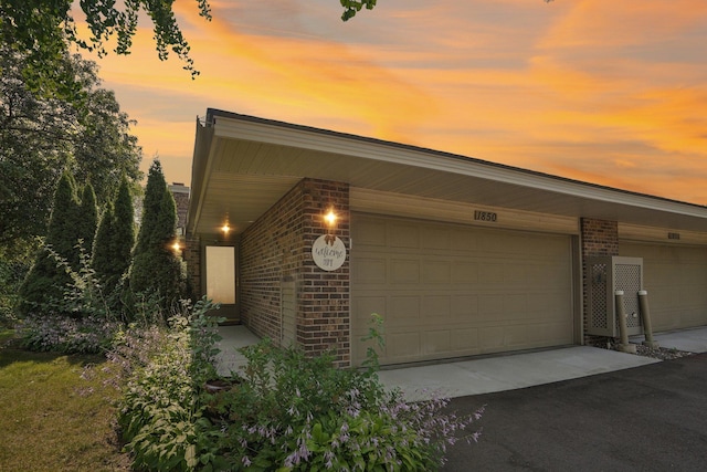 view of garage at dusk