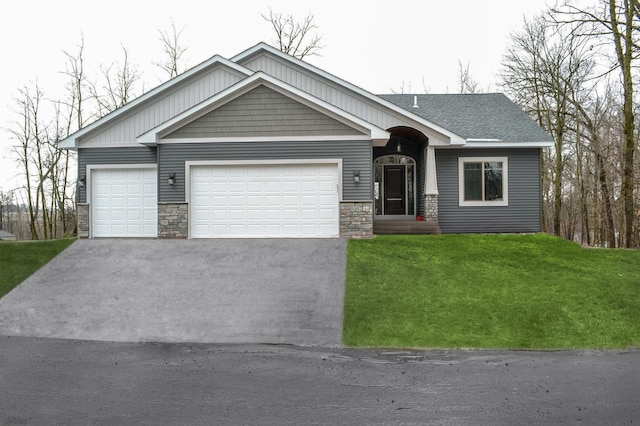 view of front of home with a front yard and a garage