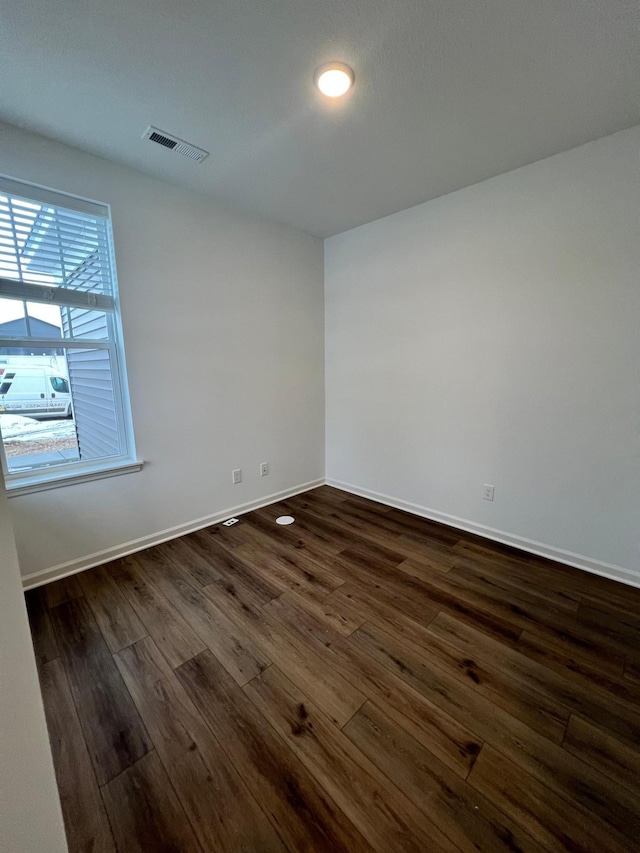 unfurnished room with dark hardwood / wood-style floors