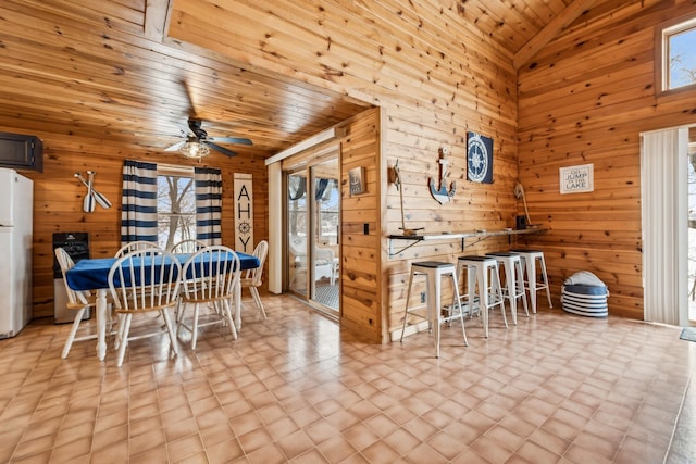 3313 Twin Island Cir NW, Prior Lake, MN 55372 - dining room with wood walls, a ceiling fan, wood ceiling, lofted ceiling, and tile patterned floors