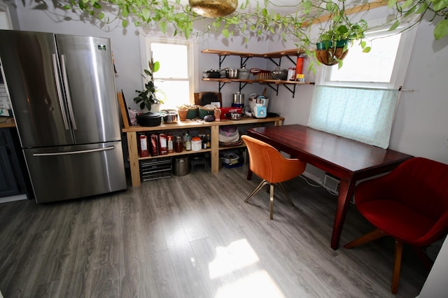 kitchen with wood finished floors, freestanding refrigerator, and open shelves