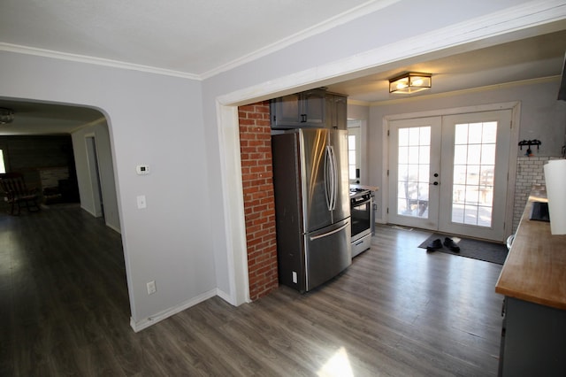 kitchen featuring dark wood-style flooring, baseboards, french doors, crown molding, and appliances with stainless steel finishes