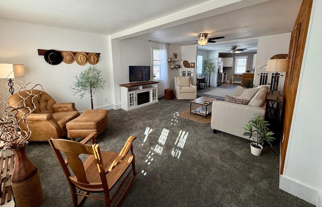 living room featuring dark carpet and ceiling fan