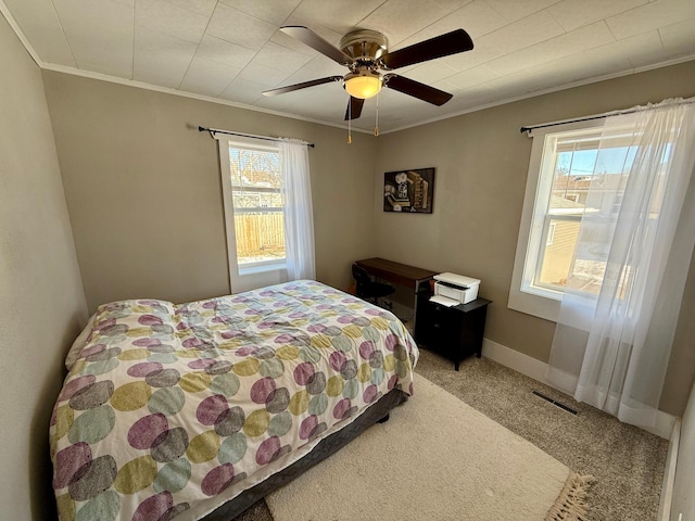 bedroom featuring ceiling fan, crown molding, and carpet