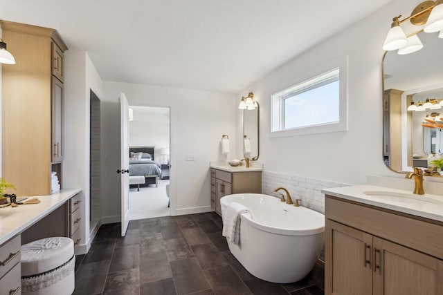 bathroom with a tub to relax in, vanity, and tile walls