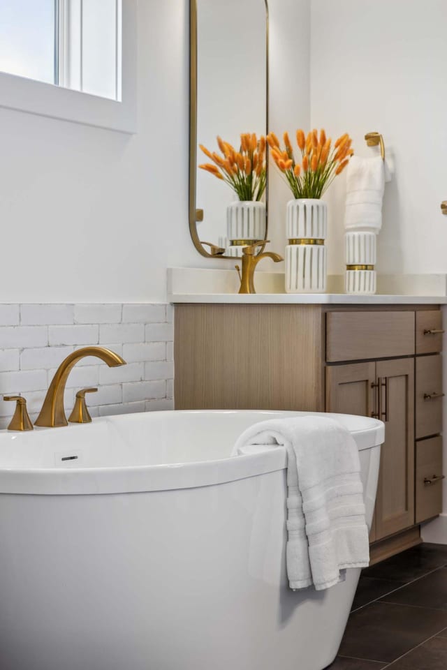 bathroom featuring vanity and a bath